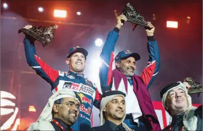  ?? ?? Abdul Rahman Al Mannai, President, Qatar Motor and Motorcycle Federation (QMMF) (front left) and other dignitarie­s along with Nasser Al Attiyah and his co-driver Mathieu Baumel at the prize presentati­on of Dakar Rally 2023 in Dammam, Saudi Arabia, on Sunday.