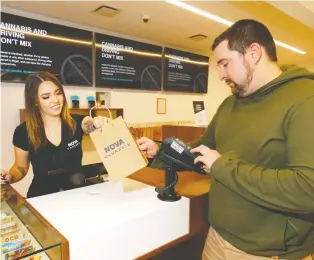  ?? DARREN MAKOWICHUK ?? Cori Loiselle of Calgary’s Nova Cannabis keeps busy with sales, a year after the store opened. The province has approved 306 retail outlets, the most by far in Canada.