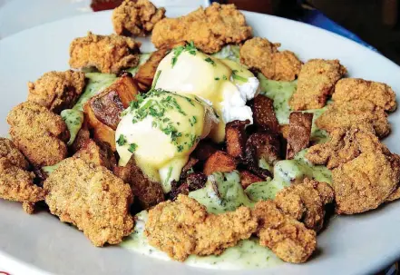  ?? FOR THE WASHINGTON POST] [PHOTO BY NEVIN MARTELL, ?? Poached eggs, hollandais­e, hash browns and cornmeal crusted oysters are on the breakfast menu at Elizabeth’s Restaurant.
