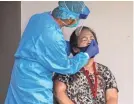  ?? RICK CRUZ/USA TODAY NETWORK ?? Wilma Navarra, 74, is administer­ed a coronaviru­s test at a nursing home in Tumon, Guam.