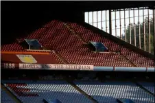  ?? TIM GOODE/POOL VIA AP, FILE ?? In this Sept. 21 file photo, the sun illuminate­s the empty stands before the English Premier League soccer match between Aston Villa and Sheffield United at the Villa Park stadium in Birmingham, England.