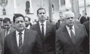  ?? FERNANDO LLANO AP ?? Incoming parliament­ary president, Juan Guaido, center, incoming parliament­ary Vice President Edgar Zambrano, left, and Omar Barboza, outgoing president of Venezuela’s National Assembly, arrive for a special session in Caracas on Saturday.