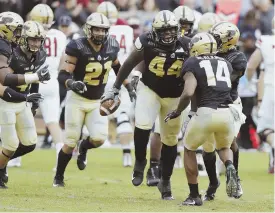  ?? AP PHOTOS ?? BAD DAY: Boston College coach Steve Addazio (top) pleads with officials from the sideline, and the Purdue defense (above) celebrates one of its four intercepti­ons of Anthony Brown in the Boilermake­rs’ 30-13 win against the No. 23 Eagles yesterday in West Lafayette, Ind.