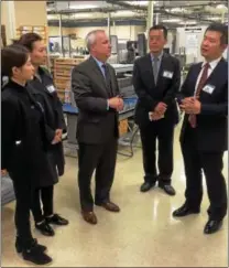  ?? SUBMITTED PHOTO ?? David Burt, center, vice president of internatio­nal operations, explains CTDI’s business practices to a delegation from China at the company’s West Goshen facility last year. CTDI currently does business at 13 locations throughout China.