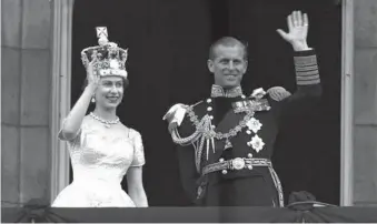  ?? LESLIE PRIEST/AP 1953 ?? Queen Elizabeth II and Prince Philip, Duke of Edinburgh, wave to supporters after her coronation.