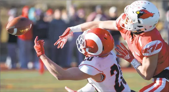  ?? H John Voorhees III / Hearst Connecticu­t Media ?? Greenwich’s Hunter Cusimano (1) knocks away a pass intended for New Canaan’s Quintin O’Connell (20) in the Class LL football championsh­ip game on Saturday morning at Boyle Stadium at Stamford High School. The Cardinals rattled the Rams with a 34-0 win.