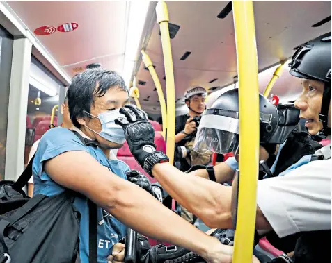  ??  ?? Protesters in Hong Kong have been using face masks to hide their identity, something China will look to outlaw
