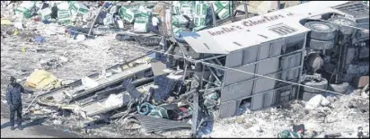  ?? CP PHOTO ?? Cargo carried by a tractor trailer and hockey equipment bags are strwn around the site of Friday’s crash that involved the Humboldt Broncos’ team bus.