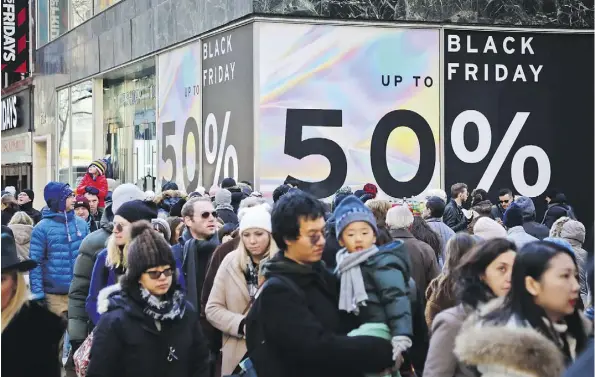  ?? BEBETO MATTHEWS/THE ASSOCIATED PRESS ?? Crowds throng the streets surrounded by Black Friday sales in New York City. The holiday shopping season presents a big test for the U.S. economy, with retail sales gains tapering off recently after a burst of spending during the first half of 2018.