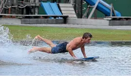  ??  ?? Torrential rain in 2015 turned Westport streets into rivers and a school playground into a makeshift pool.