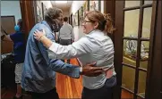  ?? GERALD HERBERT / AP ?? Henry Montgomery is greeted by staffer Cristi Cheramie inside the Louisiana Parole Project offices in Baton Rouge after he was released from the Louisiana State Penitentia­ry after serving 57 years.