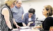  ?? Marie D. De Jesús / Houston Chronicle file ?? From left, Ann Magoon, Mal Lusky and Judy Lusky discuss last month a petition organized by Diana Miller, right, over a Sugar Land developmen­t code.