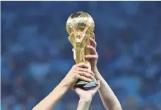  ?? PATRIK STOLLARZ/AFP/GETTY IMAGES ?? Germany is the current holder of the the World Cup trophy.