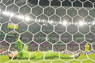  ?? MARTIN MEISSNER/ASSOCIATED PRESS ?? Croatia’s goalkeeper Dominik Livakovic celebrates beating Brazil on Friday at the World Cup in Al Rayyan, Qatar. Brazil’s Marquinhos, who only has one name, missed a penalty to lose the match.