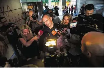  ??  ?? Seeking a last-minute reprieve Greece’s Finance Minister Yanis Varoufakis leaves his office in Athens yesterday. Greece is set to become the first developed nation to default on IMF debts.