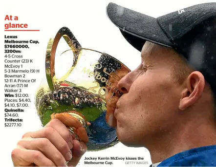  ??  ?? Jockey Kerrin McEvoy kisses the Melbourne Cup. GETTY IMAGES