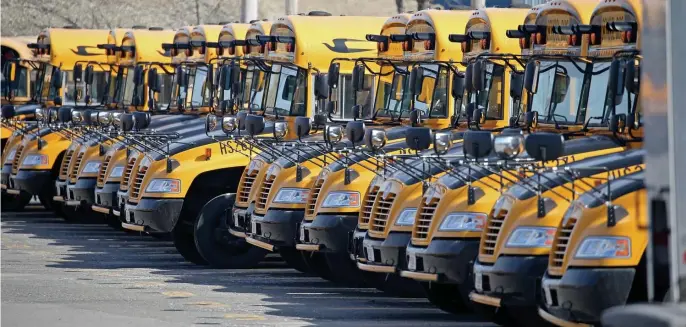  ?? STuART cAHILL / HeRALd sTAFF FILe ?? EYES OPEN FOR PROBLEMS: Boston Public School buses are lined up ready to go in Dorchester on March 10. The city will return elementary school students for full inperson learning on April 26, which may expose cases of abuse or neglect to teachers, who are required to report it if they think it’s happening.