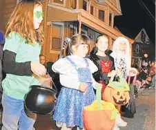  ?? MORNING CALLFILE PHOTO ?? Haley Adamson, 8, of Center Valley, Jenna Shea, 7 , and Tegan Shea, 8, both of Upper Pottsgrove, and Jordyn McKannen, of Pottstown, watch and wait for candy during the Emmaus Halloween Parade in 2012.