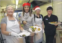  ?? Picture: Chris Davey FM4628873 ?? Maidstone and the Weald MP Helen Grant helps volunteer Margaret Monks, kitchen assistant Amanda Jeffery and cook Marcia Dungate serve a Christmas lunch at the Maidstone Day Centre in Knightride­r Street