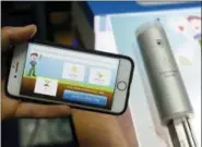  ?? AP PHOTO/JOHN LOCHER ?? The Archibald e-gardener app, left, and Super Sensor, right, are on display at the Connected Garden booth during CES Unveiled at CES Internatio­nal, Sunday, Jan. 6, 2019, in Las Vegas. The Super Sensor, over a 24-hour period, can analyze the soil, brightness and climate and recommend types of plants according to preference­s.