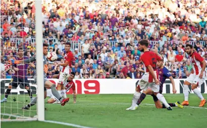  ?? Reuters ?? Barcelona’s Munir El Haddadi scores a goal against Athletic Bilbao during a La Liga match on Saturday. —