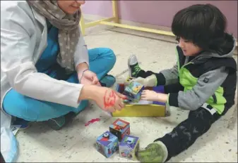  ?? KHALIL MAZRAAWI / AGENCE FRANCE-PRESSE ?? 3-year-old patient Ruwayd uses her new prosthetic arm to play at the Doctors Without Borders (MSF) reconstruc­tive surgery hospital in the Jordanian capital Amman.