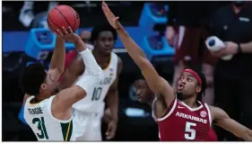  ?? (AP/Michael Conroy) ?? Baylor guard MaCio Teague (left) shoots as Arkansas guard Moses Moody defends during the first half Monday in the South Region final at Lucas Oil Stadium in Indianapol­is.