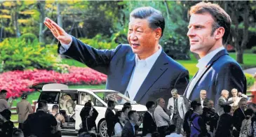  ?? REUTERS ?? A screen shows Chinese President Xi Jinping and French President Emmanuel Macron, at the GAC Motor booth at the Beijing Internatio­nal Automotive Exhibition on Thursday.