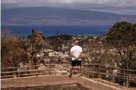  ?? Wednesday. Photograph: Yuki Iwamura/AFP/Getty Images ?? A man looks at burned buildings in the aftermath of the Maui wildfires in Lahaina on