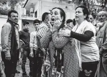  ??  ?? A woman wails as the body of a man killed during Turkish shelling arrives at a hospital in Tal Tamr, Syria.