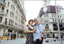  ??  ?? A couple takes a selfie against historical buildings on the Nanjing Road Pedestrian Street. — Wang Rongjiang