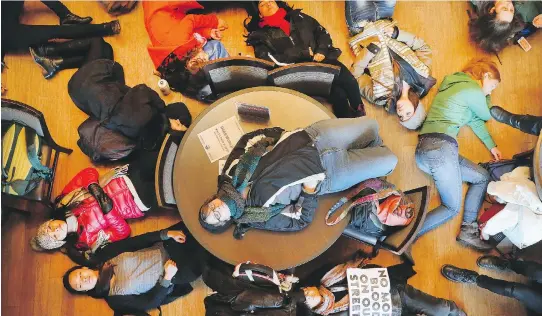  ?? SCOTT OLSON/ GETTY IMAGES ?? Students stage a ‘die-in’ at Washington University on Monday in St. Louis to draw attention to alleged police abuse. It was part a nationwide protest in the U.S. calling for workers to walk off the job and students to walk out of classes in response to...