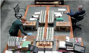  ?? NINE ?? An attendant wipes down the despatch boxes and the table just before the start of Question Time at Parliament House in Canberra.
