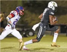  ?? STAFF PHOTO BY ROBIN RUDD ?? Bradley Central receiver Tray Curry outruns Cleveland’s Parker Chastain to score a touchdown last Oct. 4. Tennessee is among the programs Curry is considerin­g as a possible destinatio­n for his college football future, but he said will not rush his decision.