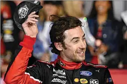  ?? MATT KELLEY / AP ?? Ryan Blaney smiles in Victory Lane after winning a NASCAR Cup Series auto race at Charlotte Motor Speedway on Monday in Concord, N.C.