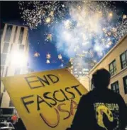  ?? AP ?? Protesters light fireworks in the middle of downtown Oakland during a demonstrat­ion on Saturday.
