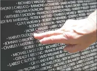  ?? BEA AHBECK/NEWS-SENTINEL ?? A person touches names on the Vietnam Moving Wall at the Weber Point Events Center in Stockton on Friday.