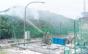  ??  ?? Bomba personnel hose the fire before it reaches the Kapit substation.