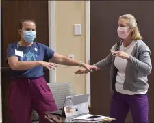  ?? PETE BANNAN - MEDIANEWS GROUP ?? Kendel-Crosswoods Communitie­s staffers Susan Mendenhall and Karen Vaile celebrate getting the Pfizer
BioNTech-COVID-19 Vaccine Friday morning January 8,
2021. Nearly 200 staff and 90 acute care residents of the facility received the first dose of the vaccine.