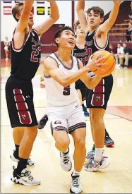  ?? Westside Eagle Observer/RANDY MOLL ?? Gentry’s Quan Tran drives between Life Way players to shoot under the basket during play in Gentry on Thursday.