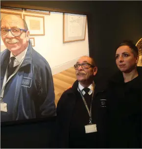  ?? Picture: Gordon Terris ?? „ National Galleries of Scotland worker Vittorio Milazzo admires his portrait by colleague Laura Nardo, right, a prize winner at the 2018 BP Portrait Award exhibition.