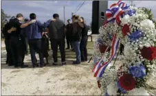  ?? AP PHOTO/ERIC GAY ?? First responders join in prayer following a Veterans Day event, Saturday near the Sutherland Springs First Baptist Church, in Sutherland Springs, Texas.