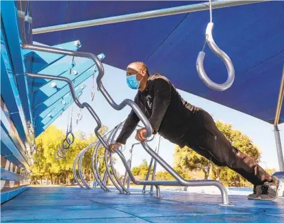  ?? CHARLIE NEUMAN ?? Steven Davis, 52, gets a morning workout at the Fitness Court at Mountain View Park in Escondido. He lives nearby and exercises here regularly. Work was completed on the court in February, but its opening was delayed due to the coronaviru­s pandemic.