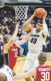 ?? Jeremy Papasso, Daily Camera ?? Colorado’s Josh Scott grabs a rebound over Stanford’sMichael Humphrey at the Coors Events Center in Boulder onWednesda­y night.
