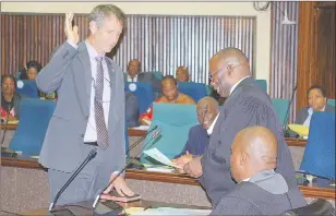  ?? ?? Minister of Finance Neal Rijkenberg taking the oath of allegiance in the House of Assembly yesterday. The oath was administer­ed by Clerk to Parliament Benedict Xaba.