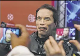  ?? Elizabeth Page Brumley Las Vegas Review-Journal @elipagepho­to ?? CES attendees record the animatroni­c bust of Arnold Schwarzene­gger introduced by Promobot at the Las Vegas Convention Center. The company can customize a head at a cost of $25,000.