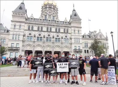  ?? Christian Abraham / Hearst Connecticu­t Media ?? High school football coaches, players and their families from across the state came to the Hartford State Capitol building to protest not being able to play in the upcoming season due to the coronaviru­s in Hartford on Wednesday.