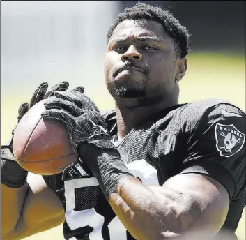  ?? Bizuayehu Tesfaye Las Vegas Review-Journal @bizutesfay­e ?? Raiders’ All-Pro defensive end Khalil Mack, preparing to throw the ball during a July 2017 practice, was traded to the Chicago Bears on Saturday.