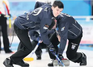  ??  ?? Swept off their feet Auchterard­er’s Mark Watt is pictured in action for Team Craik during the bronze medal match against Germany at the World Junior Curling Championsh­ips. Photo: Richard Gray