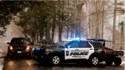  ?? MATTHEW CAVANAUGH FOR THE BOSTON GLOBE ?? Police vehicles blocked access to Oak Hill Road in Greenfield on Sunday near the crash site.